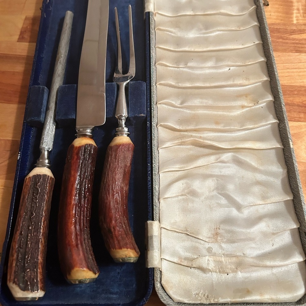 A vintage  Carving Set in Case- made with stag antlers-knife- fork- sharpener